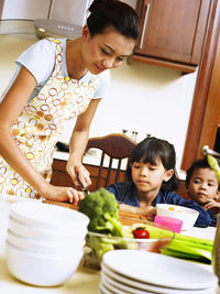 Woman with children in kitchen
