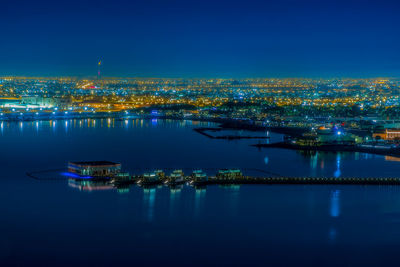 Illuminated city at waterfront