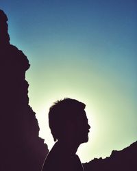 Low angle view of silhouette man against clear sky