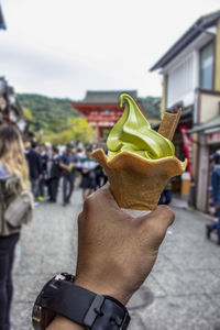 Woman holding ice cream in city