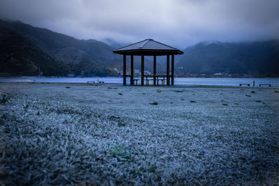 Lifeguard hut on beach against sky