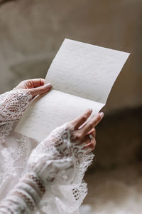 Close-up of woman holding paper with text