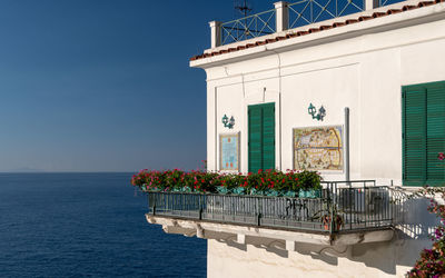 Potted plant on balcony by building against blue sky