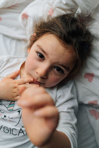 Portrait of young woman sleeping on bed at home