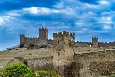 Low angle view of historic building against cloudy sky