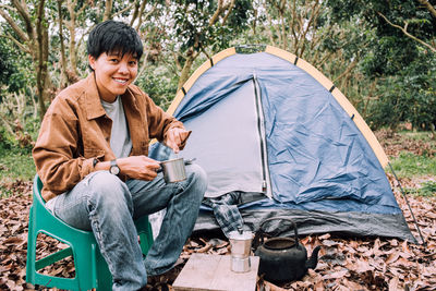 Portrait of woman sitting on tent