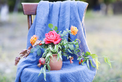 Midsection of woman holding red flowering plant