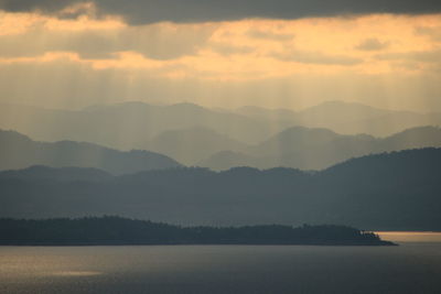 Scenic view of lake and mountains against sky