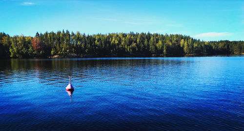 Scenic view of lake against blue sky