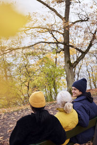 Three friends in park in autumn scenery