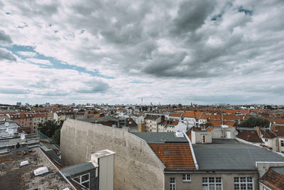 Cityscape against cloudy sky