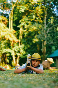 Boy lying on field in park