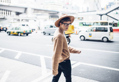 Woman standing on city street