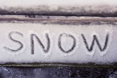 Close-up of text on snow