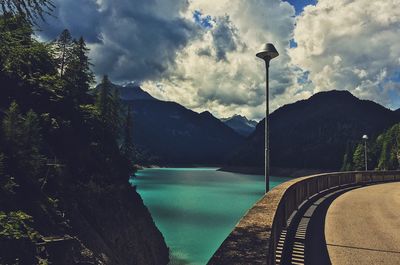 Scenic view of river against cloudy sky