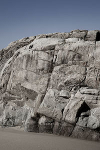 Low angle view of rock formations against sky