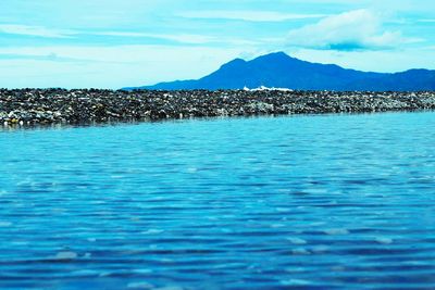 Scenic view of sea against blue sky