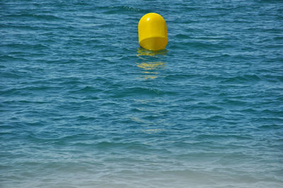 Yellow blue water floating on sea