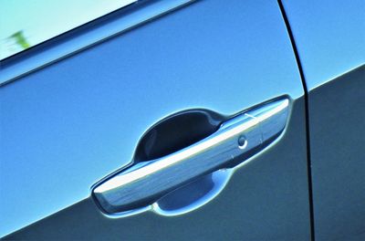 Close-up of car against blue sky