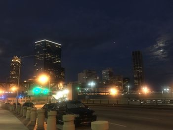 Illuminated city street at night