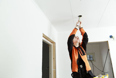 Young woman renovating house