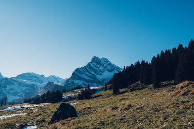 Scenic view of mountains against clear blue sky