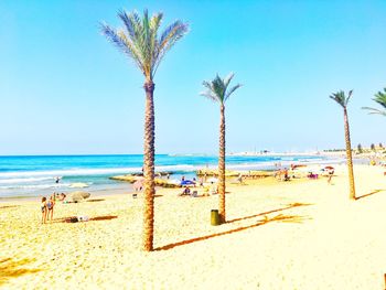 Scenic view of beach against clear blue sky