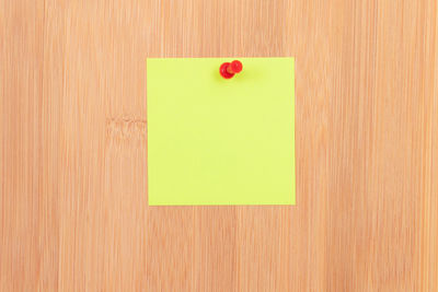 Close-up of green paper on wood