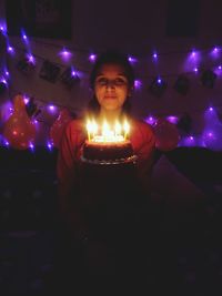 Portrait of woman with illuminated candles