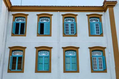 Low angle view of yellow windows on building