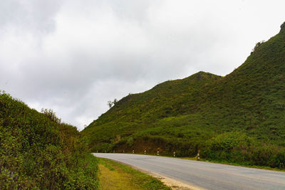 Road amidst mountains against sky