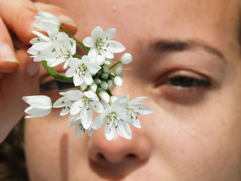 Close-up of woman holding flower