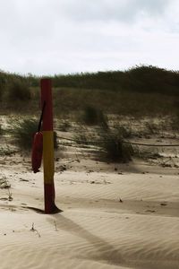 Wooden posts on field against sky