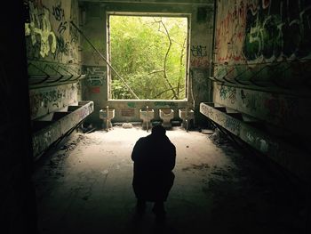 Silhouette of man in abandoned building