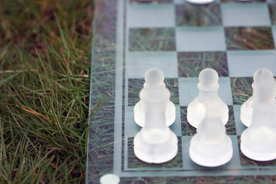 Close-up of chess board on grass