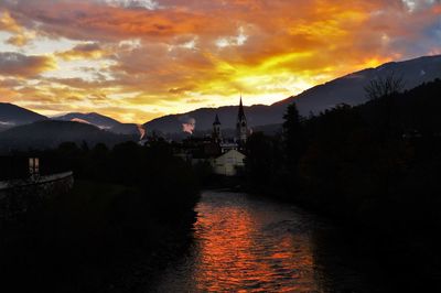 Scenic view of calm sea against orange sky