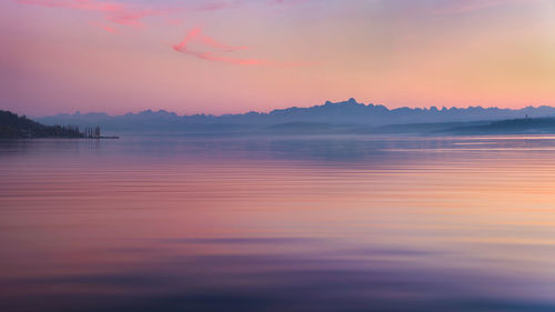 Scenic view of lake against romantic sky at sunset