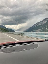 Scenic view of mountains against sky seen through car windshield