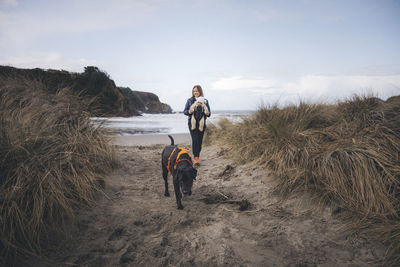 Full length of man with dog standing on land