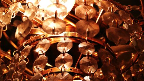 Low angle view of illuminated lanterns hanging against sky at night