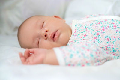 Cute baby sleeping on bed