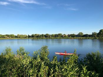 Scenic view of lake against blue sky