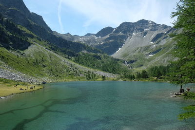 Scenic view of lake and mountains against sky