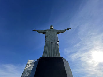 Low angle view of statue against blue sky