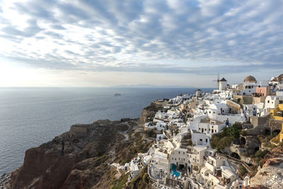 High angle view of sea and cityscape against sky