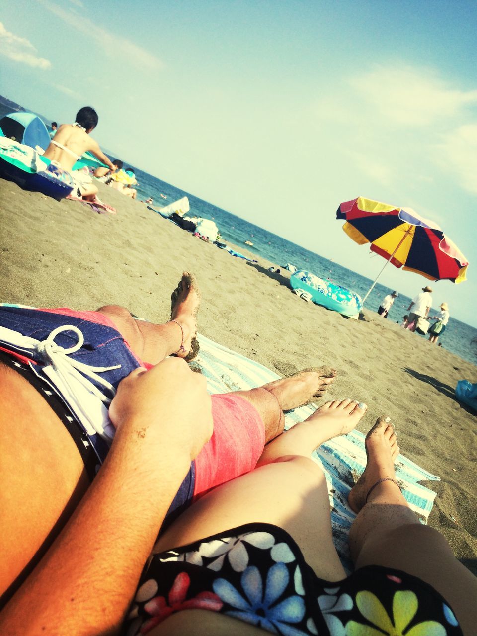 beach, sea, lifestyles, leisure activity, sand, water, vacations, low section, sky, person, shore, barefoot, horizon over water, relaxation, togetherness, summer