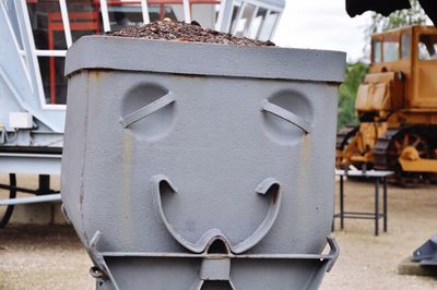 Anthropomorphic smiley face on metal at industry
