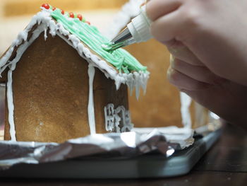 Girls making gingerbread village, happy holidays.