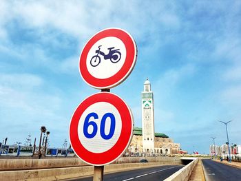 Road sign against hassan ii mosque, casablanca, morocco 