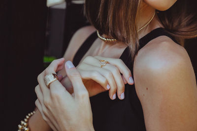 Midsection of woman holding hands